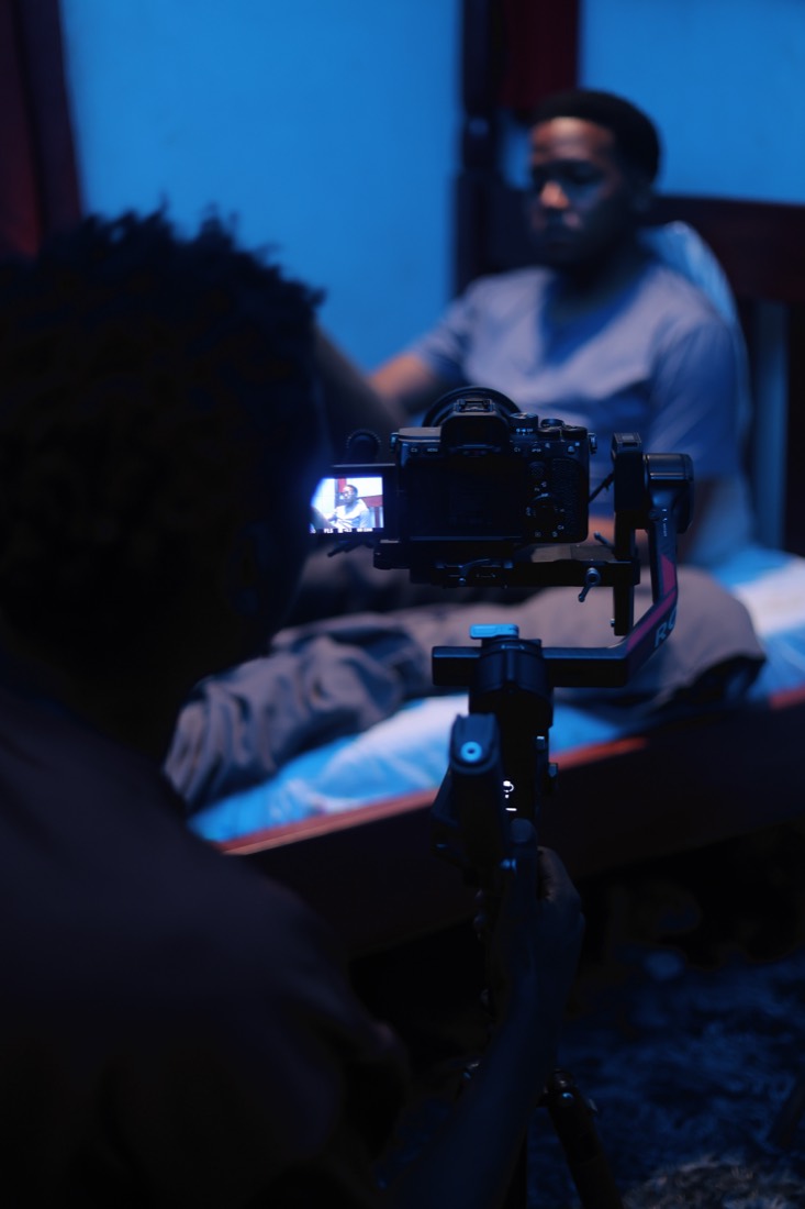 Camera operator framing a scene on set